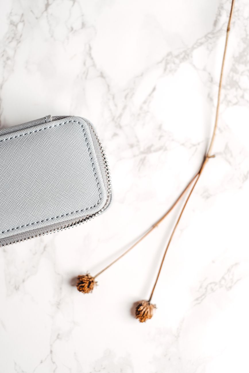 Notebook and leather travel goods arranged flatlay